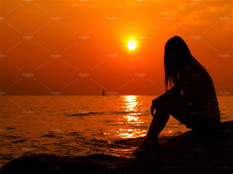 Woman Alone Watching The Sunset High Quality Nature Stock Photos
