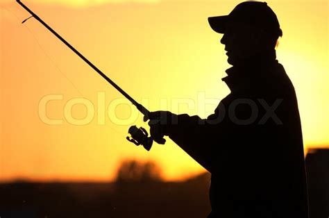 Fisherman Silhouette At Sunset Stock Photo Colourbox