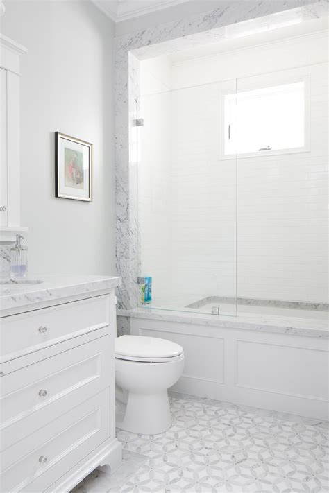 Simple subway tile offers an affordable countertop option in the bathroom of this 1920s bungalow. This white bathroom features a unique white and gray tile ...