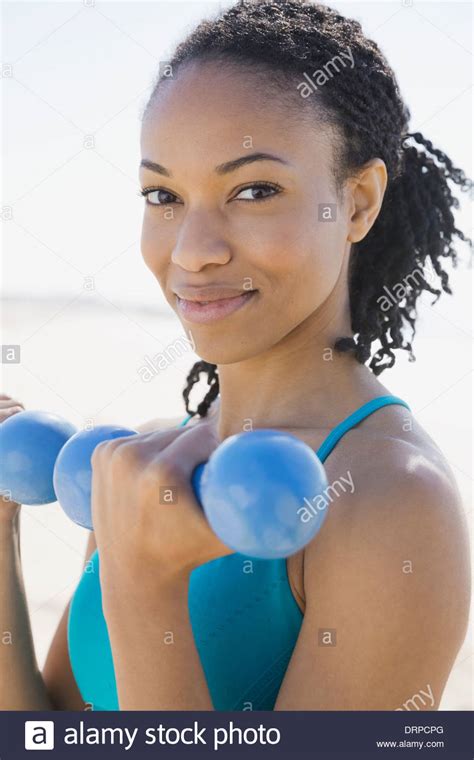 Woman Lifting Dumbbells On Beach Hi Res Stock Photography And Images