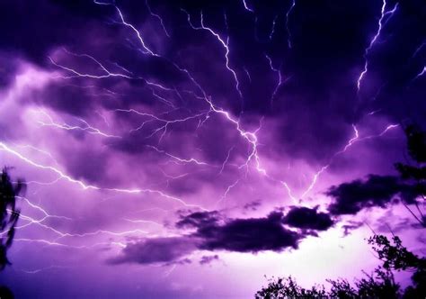 Download Striking Purple Lightning Illuminating The Night Sky