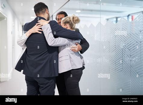 Business People Hug In The Office Hallway In A Circle As A Team For