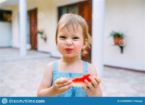 Little Cute Cheerful Girl Eating A Slice Of Watermelon Close Up Stock