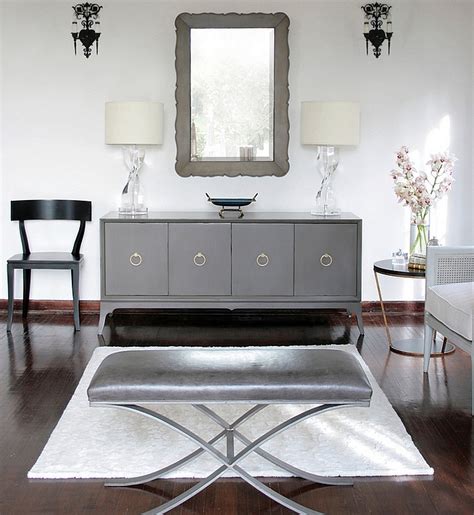 Those exquisite end tables boast of cubic design with open front, and a gray finish adorned with silver accents, composing a contrasting mosaic. Transitional living room in black and white with a hint of ...