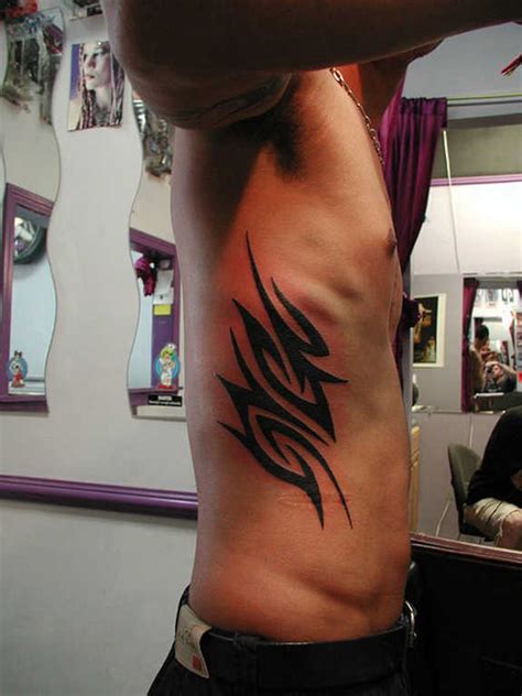 Tribal flower and irish knot tattoos on side of rib. 23 Interesting Tribal Rib Tattoos and Designs