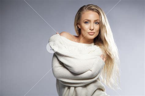 Portrait Of Sensual Young Woman Wearing Oversized Sweater Looking At Camera Beautiful Caucasian