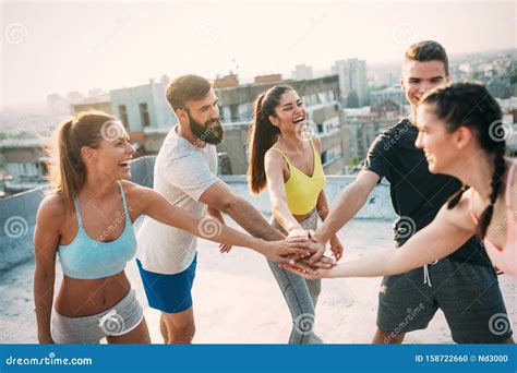 Group Of Happy Fit Young People Friends In Sportswear Doing Exercises