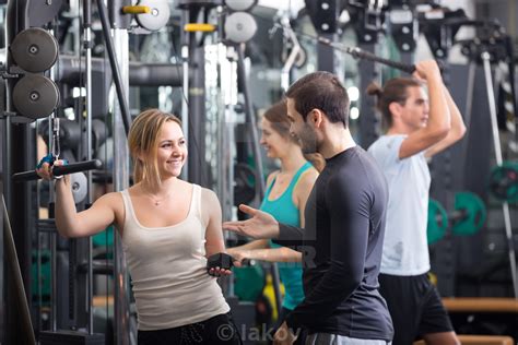 Young Adults Working Out In Fitness Club License Download Or Print