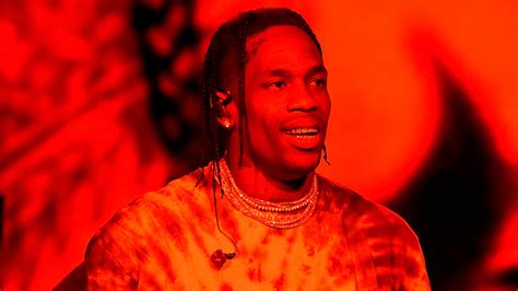Travis Scott In Red Background Wearing Gold Chains On Neck And Studs Hd
