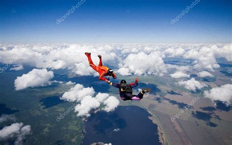 Two Skydivers Flying Over The Clouds Clouds Stock Images Free Skydiving