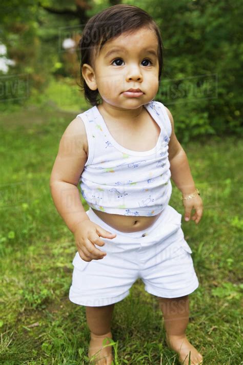 Hispanic Baby Boy Walking In Grass Stock Photo Dissolve