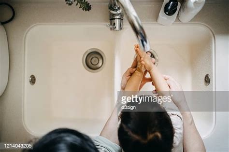 Overhead View Of A Grandmother And Granddaughter Washing Their Hands