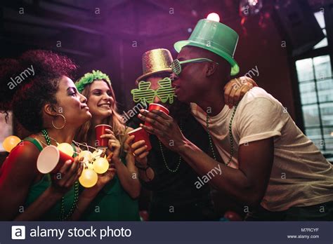 Multi Ethnic Men And Women Having Fun At The Bar Group Of Friends Celebrating St Patricks Day