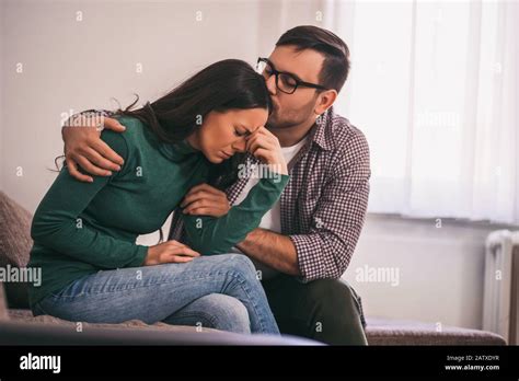 Woman Is Sad And Depressed Her Man Is Consoling Her Stock Photo Alamy