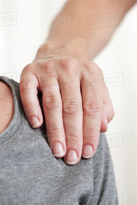 Persons Hand On Anothers Shoulder Stock Photo Dissolve