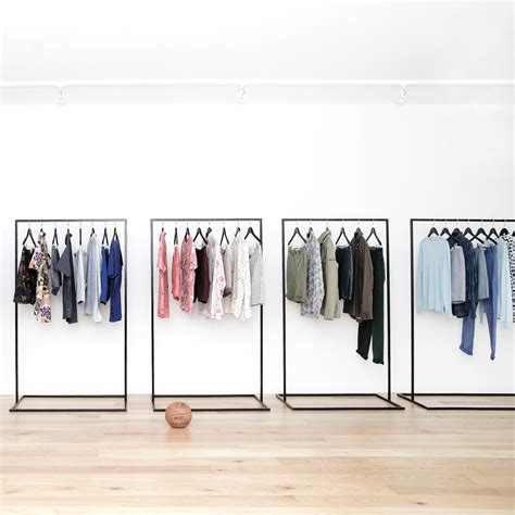 Clothes racks with dresses on hangers. Malling Living Clothes Rack Large, Black