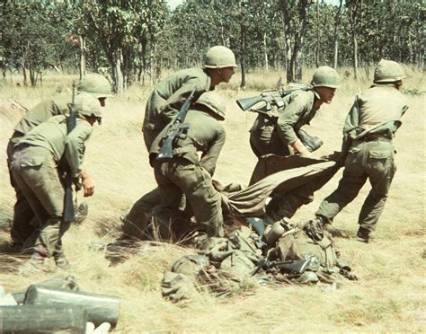 Americans From The 1st Cavalry Division Drag A Wounded Soldier To A