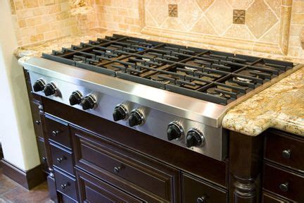To paint a laminate countertop, you first have to thoroughly clean the surface of the laminate and if you prefer a stone look, use a sponge and two similar paint colors to create a speckled effect on the. 6 burner gas range stainless steel stovetop on dark wood ...