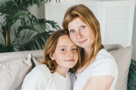 Mom And Daughter With Red Hair Mom And Daughter Teen Hugging At Home On The Couch Stock Image