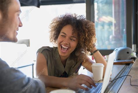 enthusiastic woman laughing in cafe stock image f015 3170 science photo library