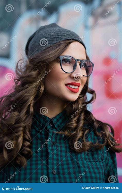 Cute Hipster Girl Is Smiling She Has Red Lips And Curly Hair She Wears Glasses For Sight Stock