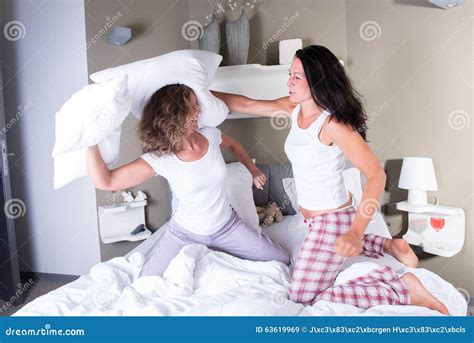 Two Attractive Women In Bed Having A Pillow Fight Stock Image Image Of Beautiful Attractive