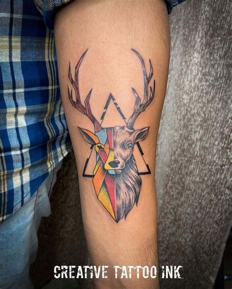 A Deer Tattoo On The Arm With Geometric Shapes And An Animals Head In It