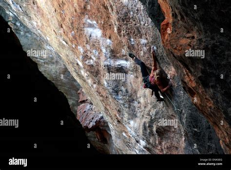 A Climber Scaling Limestone Cliffs In The Jungle At Serra Do Cipo