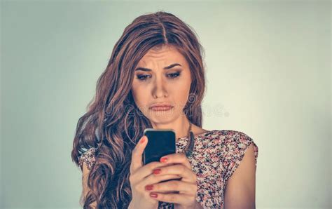 Woman Looking At Phone Message Very With Sad Expression On Face Stock Photo Image Of Alone