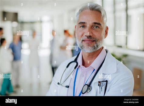 Portrait Of Happy Doctor At Hospital Corridor Stock Photo Alamy