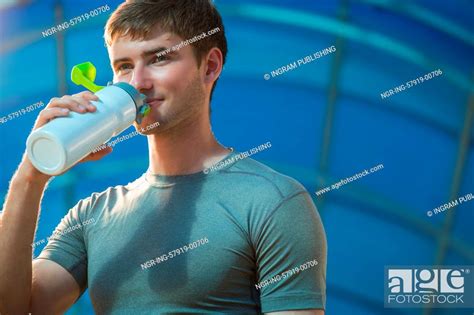 Athletic Young Man Drinking Water After Hard Training Stock Photo