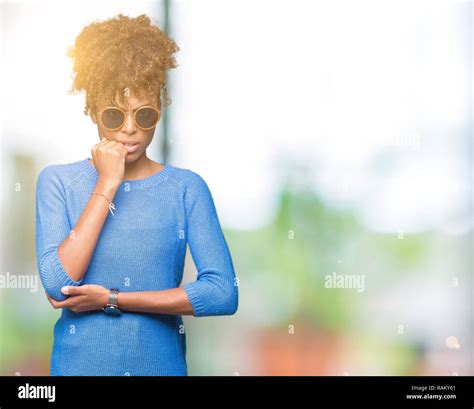 Beautiful Young African American Woman Wearing Sunglasses Over Isolated Background Looking