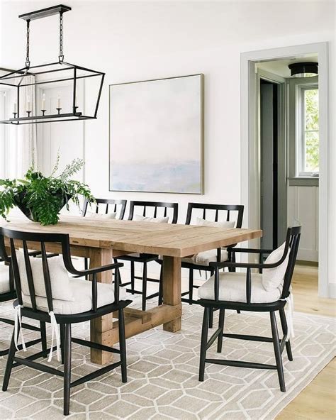 Transitional Dining Room With Black Dining Chairs Around A Beige Wood
