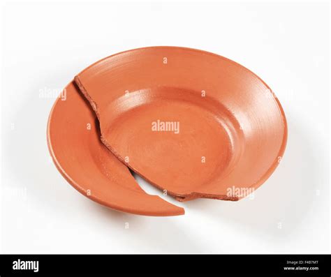 Two Pieces Of A Broken Terracotta Plate Stock Photo Alamy