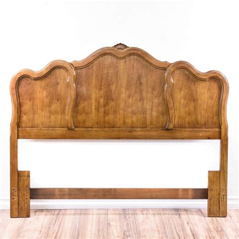 this queen sized headboard is featured in a solid wood with a glossy oak finish this