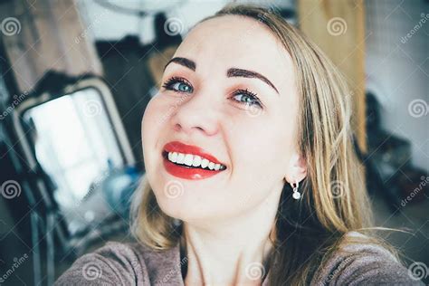 Smiling Young European Blonde Woman Making Selfie In Her Studio