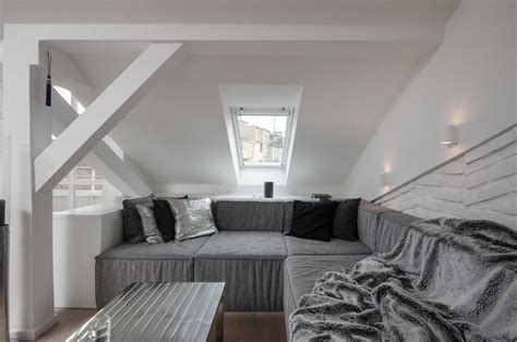 Everything above the bed in this attic bedroom is white and simple. Modern Attic Loft With Grey Palette In Prague ...