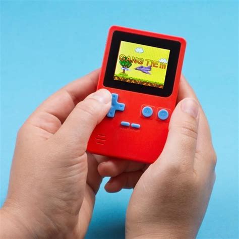 A Person Holding A Red Gameboy On A Blue Background