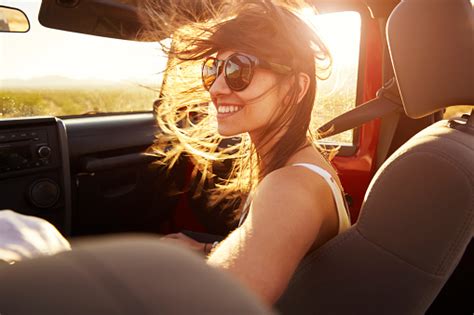 Woman Passenger On Road Trip In Convertible Car Stock