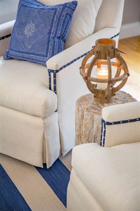 A good throw blanket is soft and adds texture to any room. White Armchair With Blue Throw Pillow | HGTV
