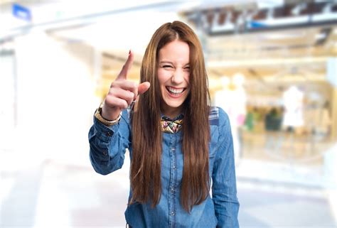 Free Photo Trendy Young Woman Looking Funny Pointing With Her Finger