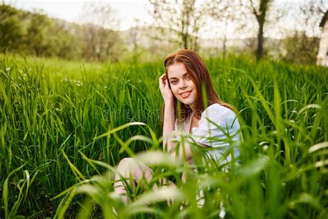 Cute Contented Woman Sitting In Tall Green Grass Outdoors Stock Image Image Of Carefree