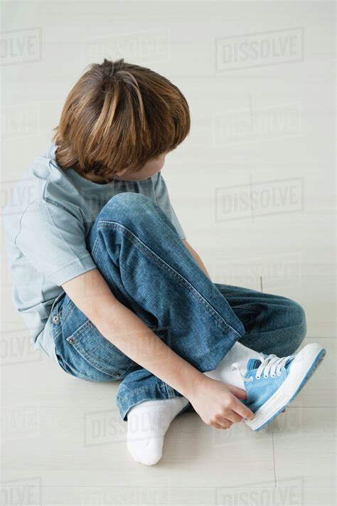 Boy Putting Shoes On Stock Photo Dissolve