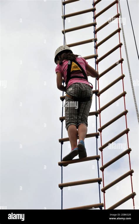 Climbing Child On A Rope Ladder Stock Photo Alamy