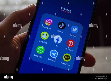 Social Media Apps Icons On Screen Hand Holding Smartphone