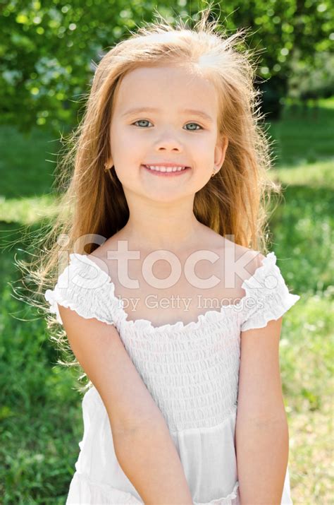 Outdoor Portrait Of Adorable Smiling Little Girl Stock Photo Royalty