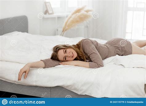 Beautiful Woman Wakes Up In Her Bed Smiles And Stretches Stock Image