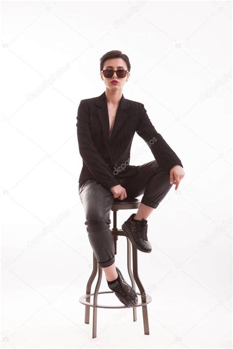 Beautiful Young Model Posing Sitting On A Chair In A High End Fashion