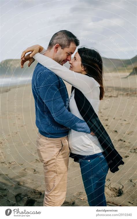 Pregnant Woman Hugging Partner On The Beach A Royalty Free Stock Photo From Photocase