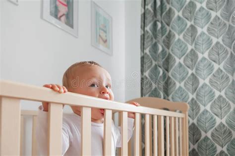 Blond Cute Little Baby Biting Wooden Bed Headboard Stock Image Image